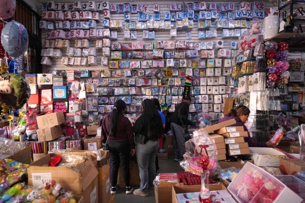 People shop at a party supply store in the Toy District of Los Angeles